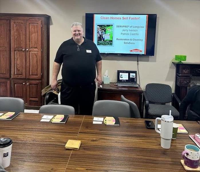 SERVPRO teacher standing in front of display screen in a classroom setting