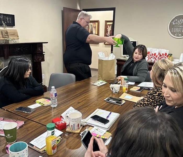 SERVPRO teacher standing in front of classroom setting