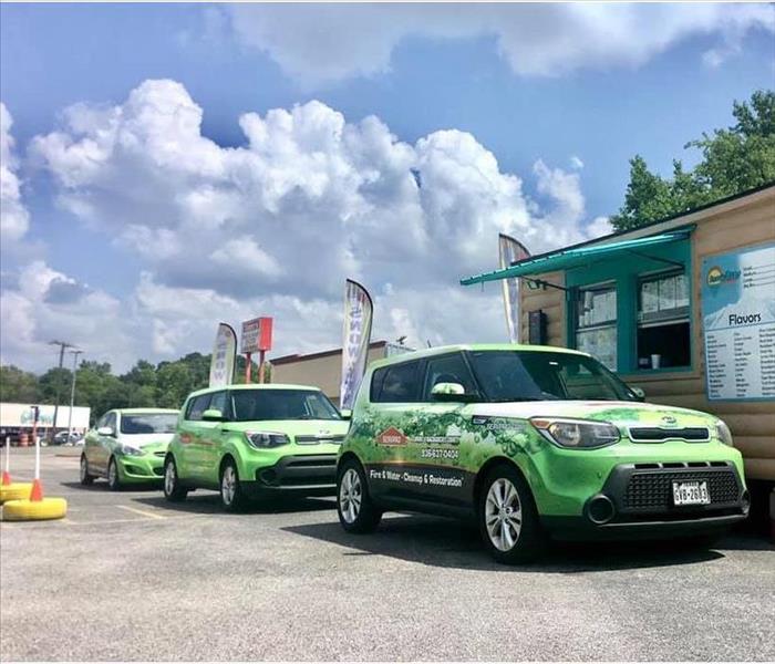 SERVPRO vehicles in a line at a local business.