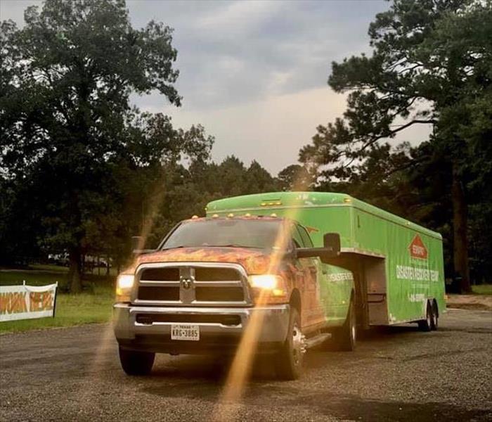 A SERVPRO truck pulling a trailer.