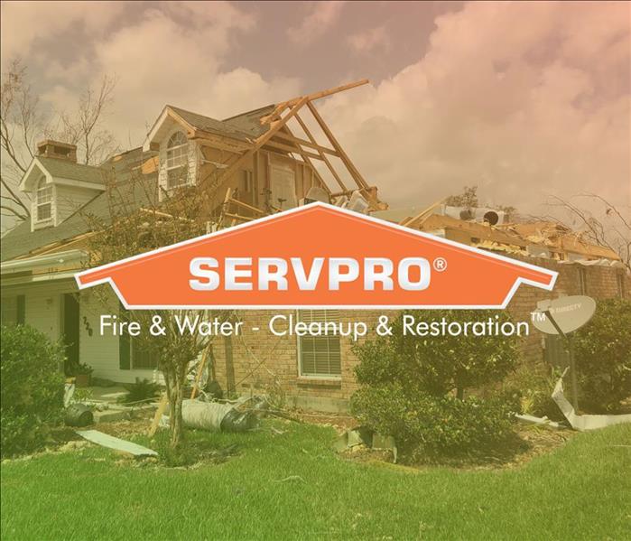 SERVPRO logo in front of severely storm damaged home 