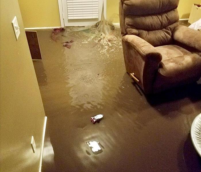 Flood water pouring in door of home