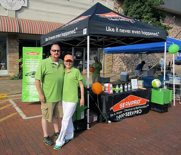 SERVPRO employees at a town event with tent