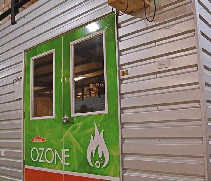 A large green door with the word OZONE on it.