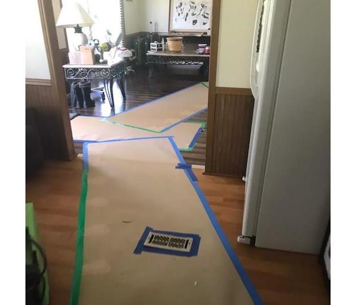 A large room that has been taped off during a water damage repair.